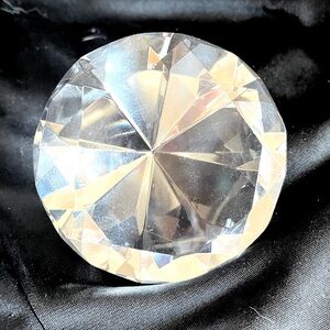 multi-faceted diamond shaped paper weight.  sparkly